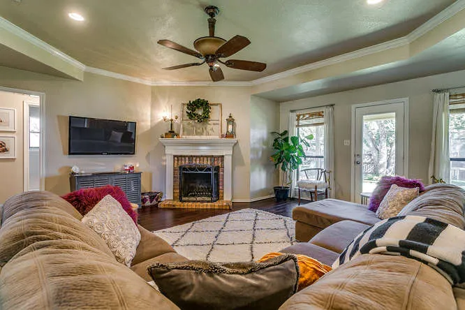 Living room with a brick fireplace in a Burleson, Texas home Team Hoover Realty Group toured with buyers