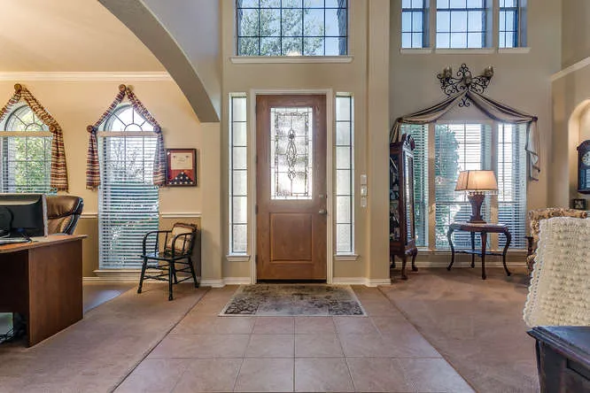 Two-story entry foyer in a Burleson, Texas home shown to buyers by Team Hoover Realty Group