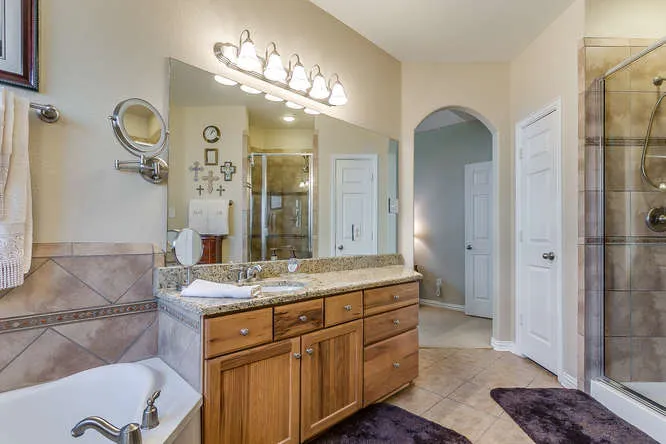 Primary bathroom with a soaking tub in a Johnson County home Gina Hoover helped clients purchase